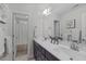 Bathroom showcasing a double sink vanity, a mirror, and a doorway to the bath and shower area at 851 Dotson Way, Apex, NC 27523