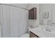 Bathroom with patterned shower curtain, vanity, and decorative accents at 851 Dotson Way, Apex, NC 27523