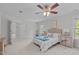 Bright primary bedroom with neutral walls, ceiling fan, and doorways at 851 Dotson Way, Apex, NC 27523