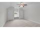 Bedroom with neutral walls, carpet, a ceiling fan, and a window seat between two closets at 851 Dotson Way, Apex, NC 27523