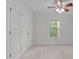 Neutral bedroom with a ceiling fan, double closets, carpet floors, and natural light from the window at 851 Dotson Way, Apex, NC 27523