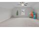 Bright bonus room with plush carpeting, a ceiling fan, and playful decor at 851 Dotson Way, Apex, NC 27523