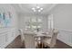 Formal dining room with wainscoting, chandelier, and ample natural light creates an elegant atmosphere at 851 Dotson Way, Apex, NC 27523