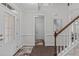 Bright foyer featuring hardwood floors, elegant trim, and a staircase leading to the upper level at 851 Dotson Way, Apex, NC 27523