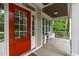 Welcoming front porch with white columns and a bright red door, offering a cozy spot to relax and enjoy the neighborhood at 851 Dotson Way, Apex, NC 27523