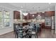 Eat-in kitchen with dark wood cabinets, granite countertops, stainless steel appliances, and breakfast nook at 851 Dotson Way, Apex, NC 27523