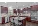 Modern kitchen with stainless steel appliances, granite countertops, dark wood cabinets, and a central island with seating at 851 Dotson Way, Apex, NC 27523