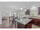 Open-concept kitchen with granite island seating flows into living and dining areas at 851 Dotson Way, Apex, NC 27523
