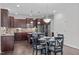 Stylish kitchen featuring granite counters, stainless appliances, dark wood cabinetry, and a dining area at 851 Dotson Way, Apex, NC 27523