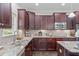 Spacious kitchen featuring granite countertops, stainless steel appliances, and ample cabinet space at 851 Dotson Way, Apex, NC 27523