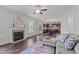 Spacious living room with fireplace seamlessly connects to the kitchen, perfect for modern living at 851 Dotson Way, Apex, NC 27523