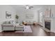 Bright living room with hardwood floors, a fireplace, comfortable seating, and stylish decor at 851 Dotson Way, Apex, NC 27523