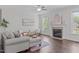 Cozy living room featuring a fireplace, hardwood floors, and neutral decor exudes comfort and style at 851 Dotson Way, Apex, NC 27523