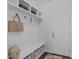 Functional mudroom with built-in storage, including a bench, hooks, and shelves, perfect for organizing outerwear and accessories at 851 Dotson Way, Apex, NC 27523