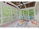 Inviting screened porch featuring wood ceiling, comfortable seating, and a patterned outdoor rug at 851 Dotson Way, Apex, NC 27523