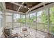 Inviting screened porch with comfortable seating, wood ceiling, and views of the lush backyard at 851 Dotson Way, Apex, NC 27523