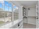 Windowed walk-in closet with built-in shelving, clothing rods, and a street view at 851 Dotson Way, Apex, NC 27523