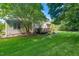 The rear exterior shows a wooden deck, a lush lawn, and mature trees for privacy at 9 Sandhill Ln, Durham, NC 27713