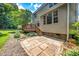 Backyard with deck and patio, with stairs connecting the two outdoor areas at 9 Sandhill Ln, Durham, NC 27713