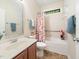Cozy bathroom featuring a bathtub, floral shower curtain, and storage at 9 Sandhill Ln, Durham, NC 27713