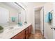 Bathroom features double sinks, vanity, and an open door to the shower and bathtub at 9 Sandhill Ln, Durham, NC 27713