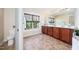 Bathroom featuring double vanity, a large mirror, and an abundance of natural light at 9 Sandhill Ln, Durham, NC 27713
