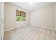 Neutral bedroom featuring carpet, window with blind, and light fixture at 9 Sandhill Ln, Durham, NC 27713
