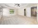 Large bedroom features a large window, neutral walls and carpet, and an open door at 9 Sandhill Ln, Durham, NC 27713