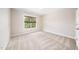Neutral bedroom featuring carpet floors, one window with wooden blinds, and a neutral paint job at 9 Sandhill Ln, Durham, NC 27713