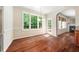 Cozy dining area features hardwood floors, large windows, and a doorway looking into the Gathering room with a fireplace at 9 Sandhill Ln, Durham, NC 27713