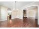 Elegant dining room featuring hardwood floors, arched doorways, and a chandelier at 9 Sandhill Ln, Durham, NC 27713