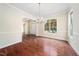 Open dining room featuring hardwood floors, a chandelier, and great natural light at 9 Sandhill Ln, Durham, NC 27713