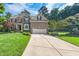 Charming home with a spacious driveway, two-car garage, and lush green lawn at 9 Sandhill Ln, Durham, NC 27713