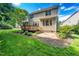 Home exterior features a well-maintained lawn, a wooden deck, and a patio perfect for outdoor living at 9 Sandhill Ln, Durham, NC 27713