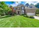 Beautiful two-story brick home featuring a well-manicured lawn and a two-car garage at 9 Sandhill Ln, Durham, NC 27713