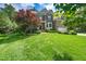 Attractive home with a lush front lawn, complemented by mature trees and shrubs at 9 Sandhill Ln, Durham, NC 27713