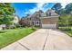 Lovely home featuring a well-manicured lawn, mature trees, and a two-car garage at 9 Sandhill Ln, Durham, NC 27713