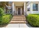 Inviting front entrance with brick steps, black railings, and well-maintained landscaping at 9 Sandhill Ln, Durham, NC 27713