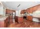 Spacious kitchen featuring an island with granite countertops, stainless steel appliances, and rich hardwood floors at 9 Sandhill Ln, Durham, NC 27713