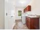Functional laundry room with cabinetry, sink, and modern washer and dryer units at 9 Sandhill Ln, Durham, NC 27713