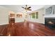 Open living room with hardwood floors, fireplace, and window views at 9 Sandhill Ln, Durham, NC 27713