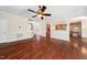 Open living room with hardwood floors, archways, and kitchen access at 9 Sandhill Ln, Durham, NC 27713