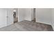 Bedroom with gray carpet, white trim, neutral walls and access to another room at 910 Rhino Bnd, Oxford, NC 27565