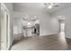 Open-concept living room featuring stainless appliances, granite counters, and white cabinetry at 910 Rhino Bnd, Oxford, NC 27565