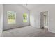 Bright bedroom with carpet, two windows, neutral walls and white trim at 910 Rhino Bnd, Oxford, NC 27565