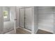 Walk-in closet with shelving, adjacent to the shower with glass doors and modern fixtures at 910 Rhino Bnd, Oxford, NC 27565