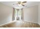 Comfortable bedroom with plush carpet and windows dressed with contemporary curtains at 9400 Leslieshire Dr, Raleigh, NC 27615