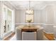 Dining room with hardwood floors, modern lighting, and seating for eight at 9400 Leslieshire Dr, Raleigh, NC 27615