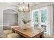 Elegant dining room with hardwood floors, modern chandelier, and open floor plan at 9400 Leslieshire Dr, Raleigh, NC 27615