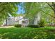 Charming two-story home featuring a manicured lawn, inviting front porch, and an American flag display at 9400 Leslieshire Dr, Raleigh, NC 27615